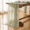 120-inch (10 ft) green cheesecloth table runner, perfect for adding a rustic boho touch to weddings, baby showers, bridal showers, or home décor. This sheer gauze runner serves as an elegant centerpiece, ideal for creating a soft, textured look on an